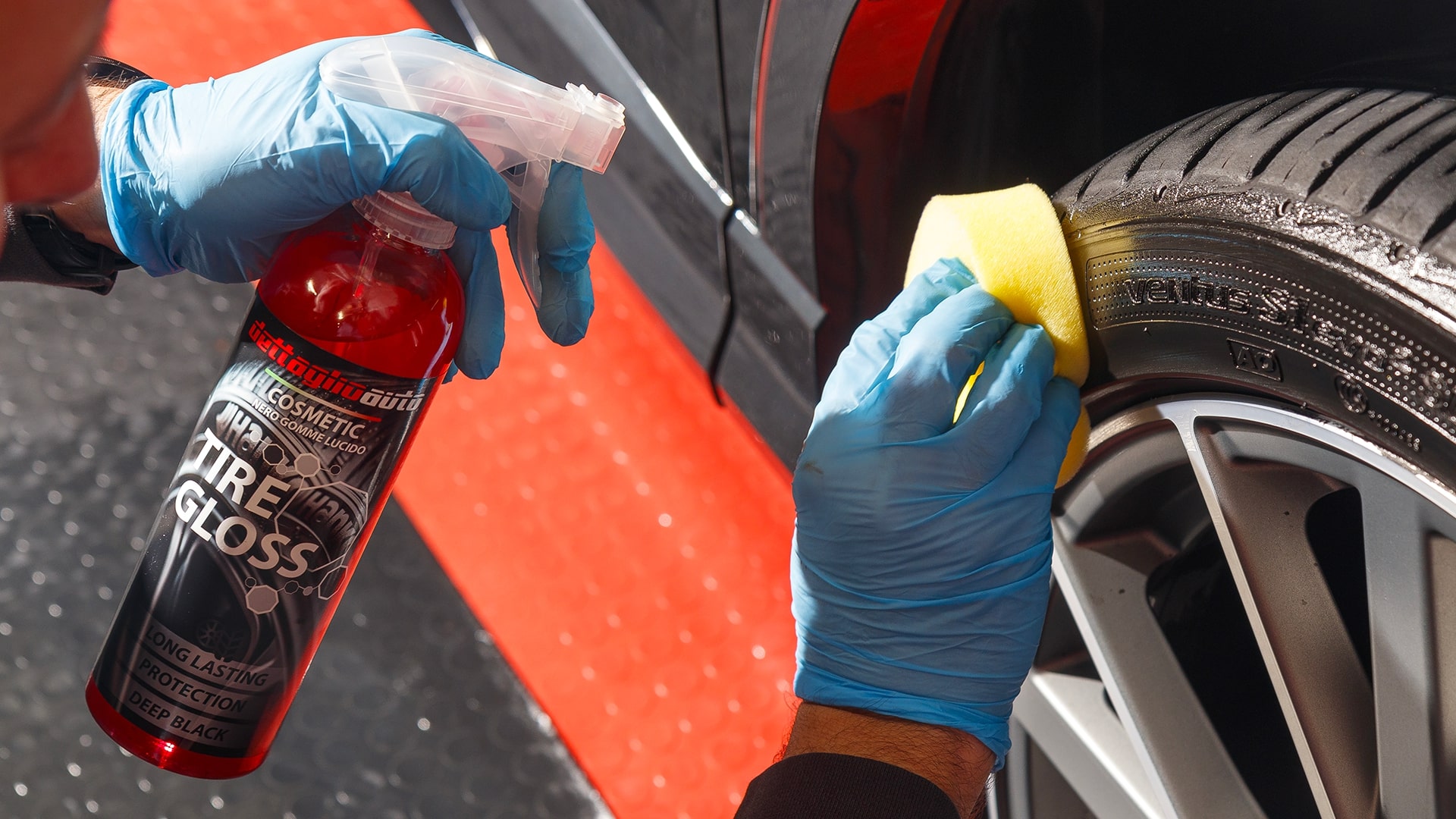 exterior car detailing with the application of a cream on a wheel