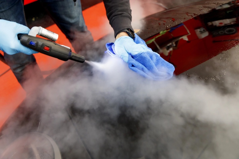 Steam car wash on a car hood