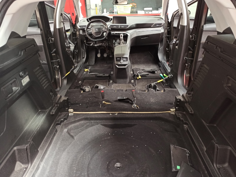 Car interiors disassembled without seats for professional interior cleaning